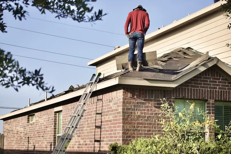 Professional roofer working on a residential roof in Baldwin Estates